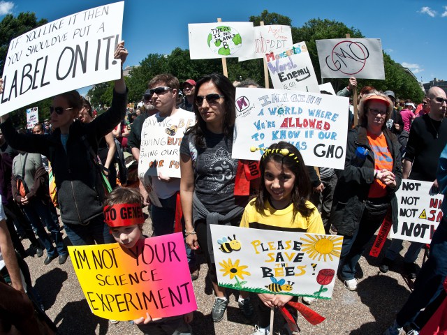People hold signs during a demonstration against agribusiness giant Monsanto and genetically modified organisms (GMO) in front of the White House in Washington on May 25, 2013. (Photo/NICHOLAS KAMM/AFP/Getty Images)