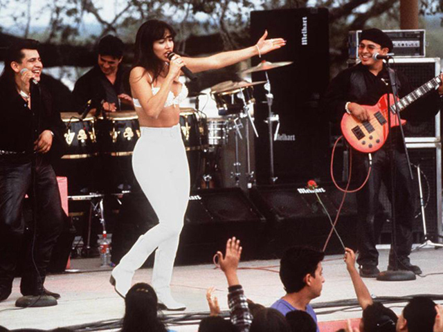Actress Jennifer Lopez, who plays Selena in the movie “Selena,” performs with her band in one of the scenes from the movie. (RICCO TORRES/AFP/Getty Images)